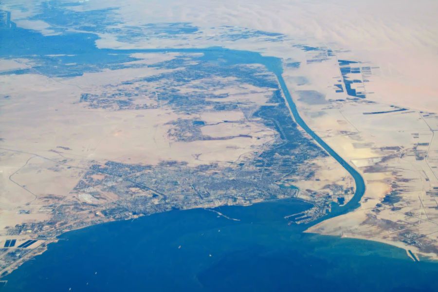 The city of Suez and the southern entrance of the Suez Canal seen from the air, with the canal running north through the desert.